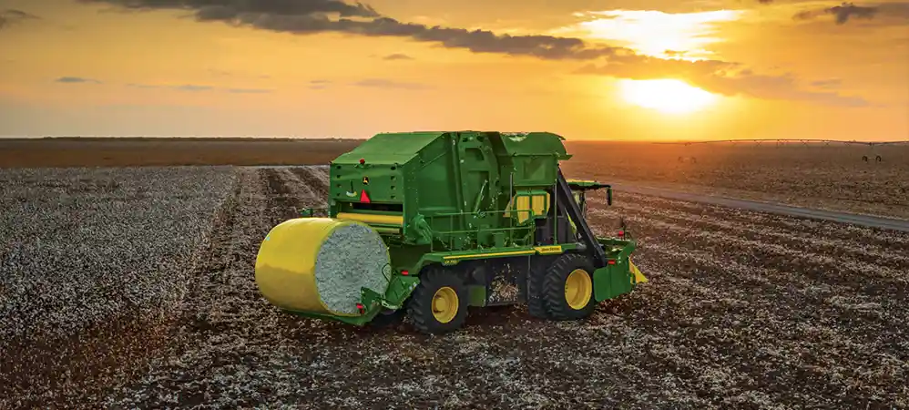 cotton pickeר with cotton bale